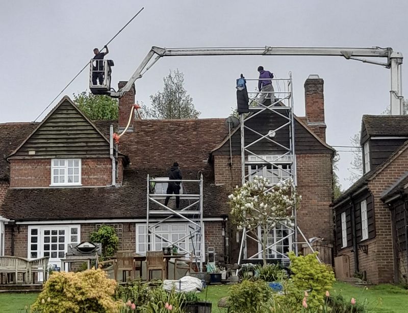The Moss Cleaners using cherry picker and scaffolding to clean roof safely and professionally in Havant, Hampshire